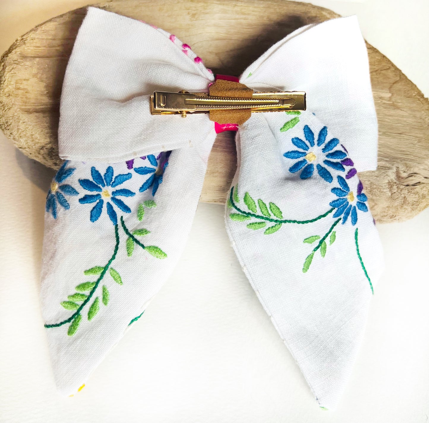 Back of large embroidered hair bows being added