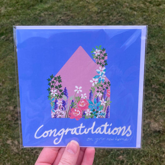 Square Blue Card featuring a house surrounded by flowers and new home congratulations 