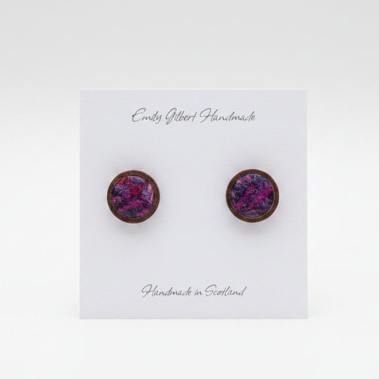 Purple round earrings on a 'Emily Gilbert Handmade' card held by a hand.
